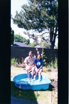 Dad and I cooling in the toy pool. (In the backyard of our home in Canada.)
