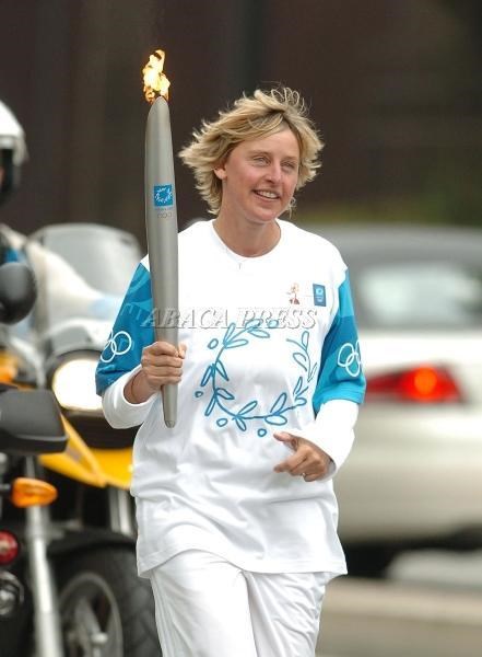 Ellen DeGeneres,  is escorted as she runs her leg of the <a href=http://www.viewimages.com/Search.aspx?mid=72520050&epmid=3&partner=Google>Olympic torch relay</a> in the Hollywood section of Los Angeles, June 16, 2004.