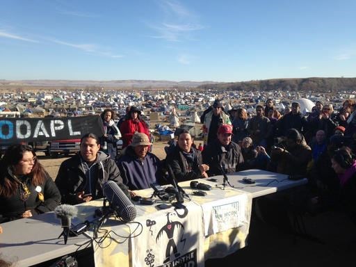 Organizers of protests against construction of the Dakota Access oil pipeline speak at a news conference on Saturday, Nov. 26, 2016, near Cannon Ball, N.D. They said they have a right to remain on land where they have been camped for months. They made the statement a day after tribal leaders received a letter from the U.S. Army Corps of Engineers, telling them the land would be closed to the public on Dec. 5. (AP Photo/James MacPherson)