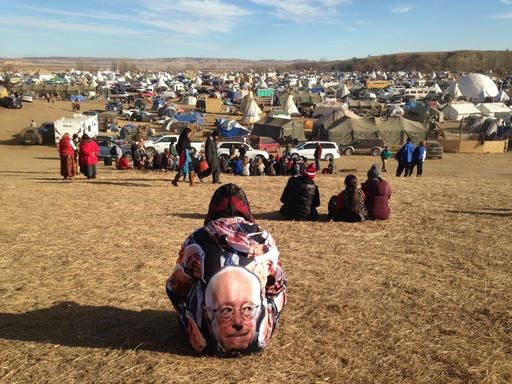 Protesters gather at an encampment on Saturday, Nov. 26, 2016, a day after tribal leaders received a letter from the U.S. Army Corps of Engineers that told them the federal land would be closed to the public on Dec. 5, near Cannon Ball, N.D. The protesters said Saturday that they do not plan to leave and will continue to oppose construction of the Dakota Access oil pipeline. (AP photo/James MacPherson)