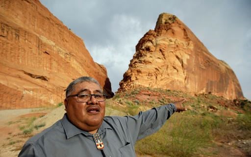 This June 21, 2016, file photo, Malcolm Lehi, a Ute Mountain Tribal Commissioner points to a rock formation near Blanding, Utah. 