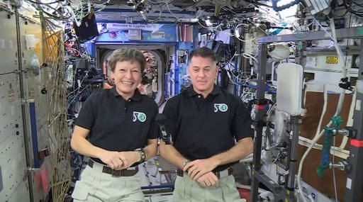 In this image made from video provided by NASA, U.S. astronauts Peggy Whitson, left, and Shane Kimbrough speak from the International Space Station during an interview on Tuesday, Jan. 3, 2017. The two are scheduled to perform spacewalks to replace batteries for the station on Friday and the following week. (NASA via AP)