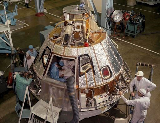 In this 1966 photo made available by NASA, technicians work on the Spacecraft 012 Command Module at Cape Kennedy, Fla., for the Apollo/Saturn 204 mission. During a launch pad test on Jan. 27, 1967, a flash fire erupted inside the capsule killing three Apollo crew members. (NASA via AP)