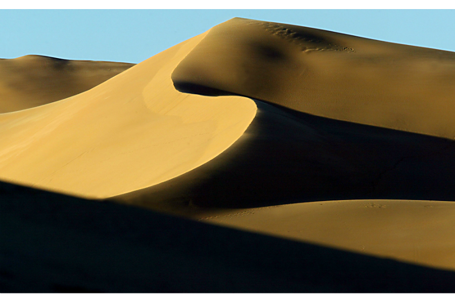 Huge sand dunes of the Sahara desert wind through the outskirts of Ghadames, Libya, 2004. (John Moore/AP/File)