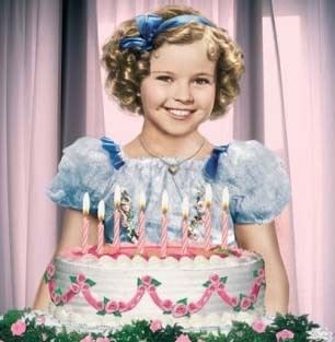 Shirley Temple smiling with her birthday cake. (http://princessportal.com/blog/wp-content/uploads/2008/11/shirleytemple.jpg)