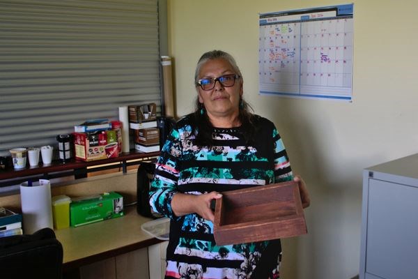 Gayle Chase holds a smudge box, used in Blackfoot tradition to purify one's mind, at the Blood Tribe reserve (also known as the Kainai nation) in the town of Standoff, Alberta. Photo - Dylan C. Robertson