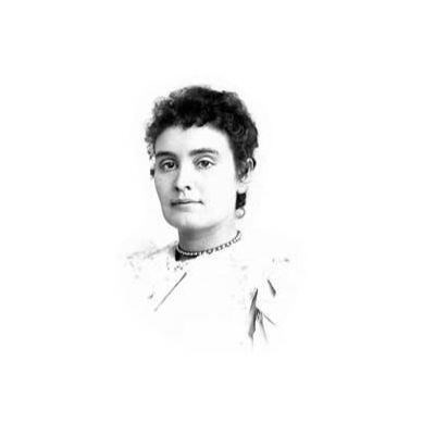 Head and shoulders portrait of Anne Sullivan. In this image, Anne faces the viewer with a slight smile.  Her light-colored dress has a high neck and she wears a necklace.