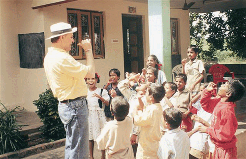 The doctor with a group of orphans (Dr. Kataria)