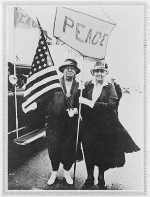 Jane Addams on the left holding the U.S. flag  (