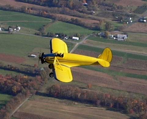 This is a yellow kinner airster biplane. (http://www.amazingaircraft.com/ ())