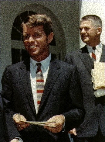 Attorney General of the United States Robert F. Kennedy, Solicitor General Archibald Cox in background, May 7, 1963. White House, Stoughton.<br>Photo courtesy of John F. Kennedy Library and Museum