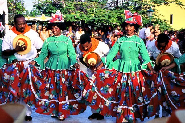 Costumed dancers perform a folk dance for tourists at a restored plantation in Curacao. The island nation in the southern Caribbean is considering using cold seawater drawn up from the ocean's depths to generate electricity.  <P>R. Norman Matheny/Staff/File