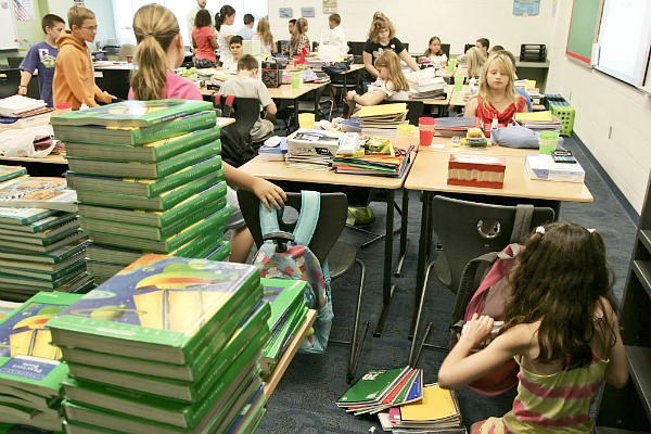 Student gather on the first day of school at Wyandotte Elementary School near Lafayette, Ind., in 2011. Wyandotte is one of many US schools that have made cutting energy use a priority. In Richardsville, Ky., one elementary school is more than 'net zero': It sells about $2,000 in electricity each month back to the local utility. <P> Michael Heinz/The Journal & Courier/AP/File