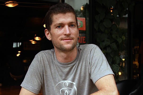 Colorado native Colin Flahive sits at the bar of Salvador’s Coffee House in Kunming, the capital of China’s southwestern Yunnan Province. Employing young women from rural areas led him to take a number of steps to help his employees and the community.  <P>Michael Ives