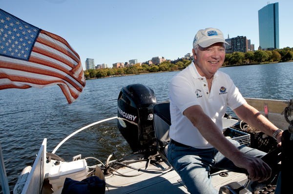 Tom McNichol cleans up trash on the Charles River in Boston. The Charles River Clean Up Boat has been operating for 10 years.  <P>Melanie Stetson Freeman/Staff