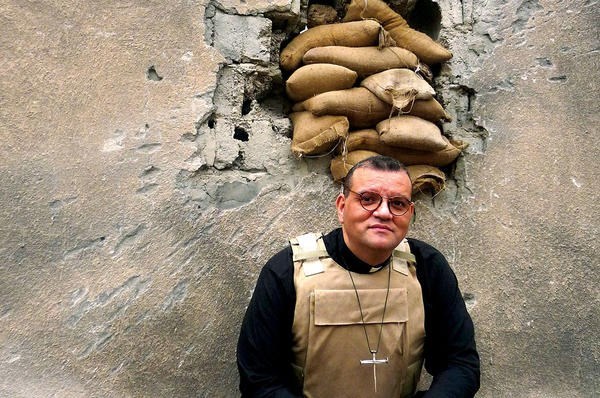 The Rev. Canon Andrew White, vicar of the only Anglican church in Baghdad, is seen wearing a bulletproof vest. <P>Courtesy of FRRME