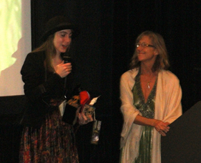 Slater Kemker-Jewell receving her 1st Place Indy Features in Development award from the Film Festival director Wendy Milette, for her excerpt of An Inconvenient Youth