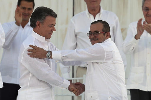 In this Monday, Sept. 26, 2016 file photo, Colombia’s President Juan Manuel Santos, left, and the top commander of the Revolutionary Armed Forces of Colombia (FARC) Rodrigo Londono, known by the alias Timochenko, shake hands after signing a peace agreement between Colombia’s government and the FARC to end over 50 years of conflict in Cartagena, Colombia. Santos won the Nobel Peace Prize Friday, Oct. 7, for his efforts to end a civil war that killed more than 200,000 Colombians. (AP Photo/Fernando Vergara, File)