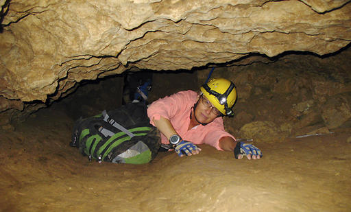 In this July 3, 2008, file photo, New Mexico Tech professor Penny Boston crawls through the Mud Turtle Passage on the way to the Snowy River formation during an expedition in Fort Stanton Cave, N.M. Boston, who discovered extreme life in New Mexico caves in 2008, presented new findings on Friday, Feb. 17, 2017 of microbes trapped in crystals in Mexico that could be 50,000 years old. (AP Photo/Susan Montoya Bryan)