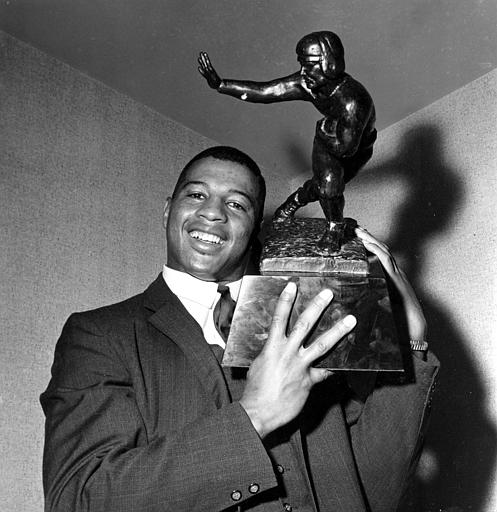 Ernie Davis holding his Heisman Trophy (https://uk.pinterest.com/pin/459156124483711292/ (Unknown))