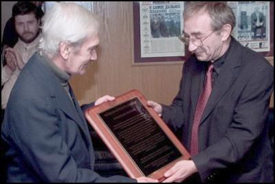 Stanislav (left) receiving an honourary plaque