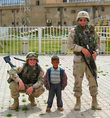 Two American soldiers with a small boy