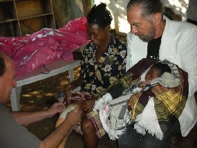 John Paul putting legs on victim in Africa