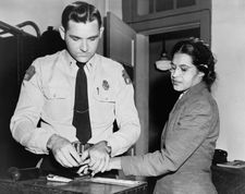 This is a shot of Rosa Parks being fingerprinted. (http://en.wikipedia.org/wiki/Rosa_Parks)
