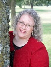 My mom leaning on a tree 