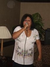 Ana Rosario-singing at a family event.