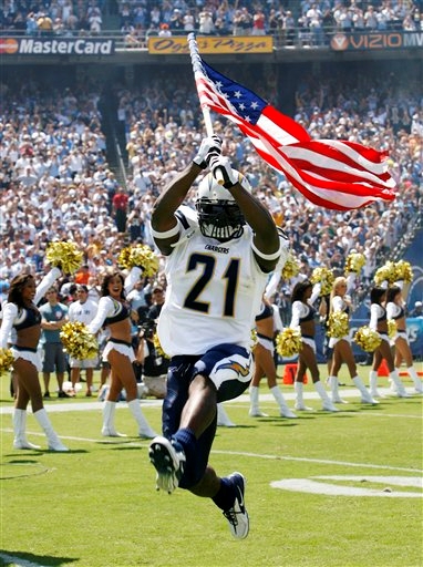 LaDainian running with an American flag.