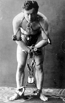 Harry Houdini about to escape (Wikipedia)