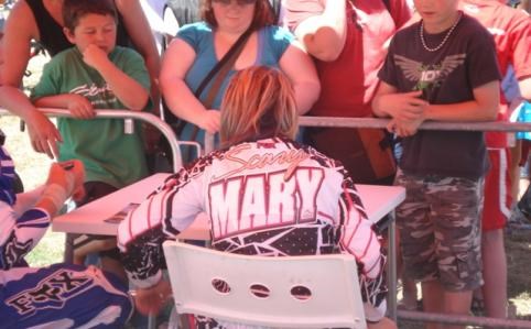 Mary signing autographs