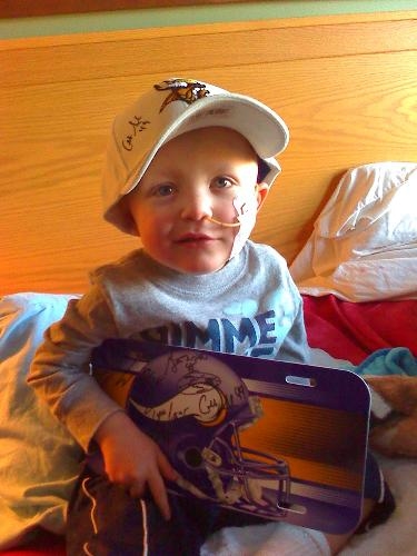Seth, my brother, holding the Vikings autographs (caringbridge.org )