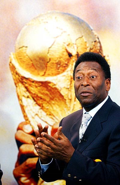 Pele is receiving awards and giving a speech. (http://famous-football-players-biography.blogspot.com/2008_02_01_archive.html)