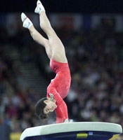 Oksana doing a flip over the vault