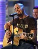 Chris Daughtry playing his guitar at a concert