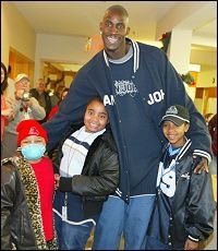 Garnett taking a picture with some local kids (http://www.bing.com)