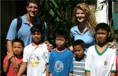 Tim and his older sister Christy with orphans in 