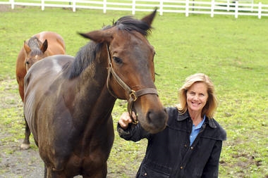 Erin Hurley, who runs the nonprofit South Jersey Thoroughbred Rescue and Adoption, Inc., stands with one of her charges in a paddock at Stillpond Farm in Moorestown, N.J. Racehorses have notoriously short careers, but can be retrained.