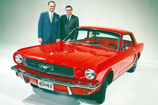 Iacocca standing next to a model Mustang (http://www.selectism.com/news/wp-content/uploads/2010/03/frey-ford-mustang.jpg)