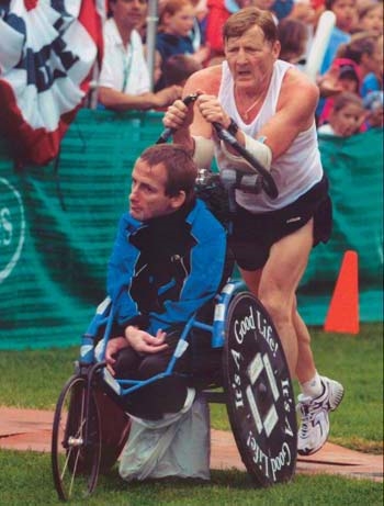 Dick running in a marathon while pushing Rick. (online)