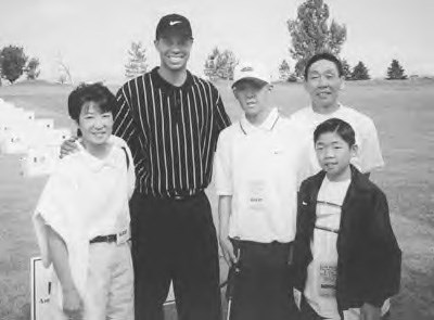 Brandon and his family with Tiger Woods