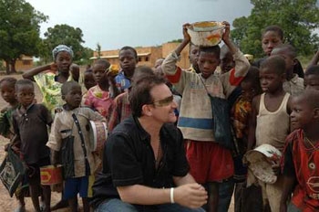 Bono helping out in Africa (http://roadsofstone.com/2006/09/19/124-exploring-africa-with-bono/)