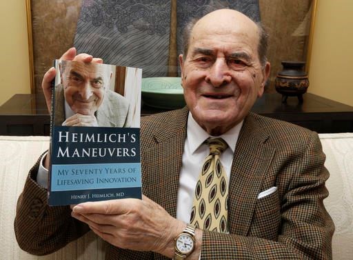 In this Feb. 5, 2014, file photo, Dr. Henry Heimlich holds his memoir prior to being interviewed at his home in Cincinnati. Heimlich, the surgeon who created the life-saving Heimlich maneuver for choking victims has died Saturday, Dec. 17, 2016, at Christ Hospital in Cincinnati. He was 96. (AP Photo/Al Behrman, File)