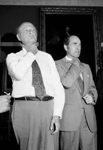 In this Aug. 7, 1981, file photo, Dr. Henry Heimlich, right, and Mayor Edward Koch demonstrate how a chocking victim should signal for help at New York's City Hall during Heimlich's discussion of his Heimlich Maneuver. Heimlich, the surgeon who created the life-saving Heimlich maneuver for choking victims has died Saturday, Dec. 17, 2016, at Christ Hospital in Cincinnati. He was 96. (AP Photo/Suzanne Vlamis, File)