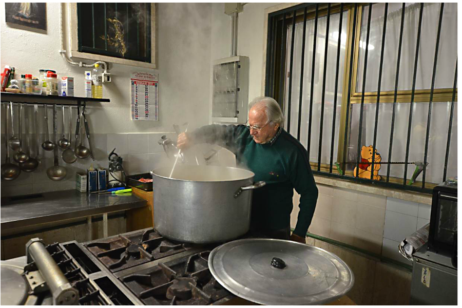 Italian pensioner Dino Impagliazzo cooks a meal for poor people on Jan. 23 using food that would have gone to waste in Rome. Photo: Umberto Bacchi  Thomson Reuters Foundation