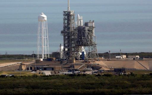 A Space X Falcon 9 rocket sits on the launch pad, Saturday, Feb. 18, 2017 at the Kennedy Space Center in Cape Canaveral, Fla Last-minute rocket trouble forced SpaceX on Saturday to delay its inaugural launch from NASA's historic moon pad. SpaceX halted the countdown with just 13 seconds remaining. The problem with the second-stage thrust control actually cropped up several minutes earlier. With just a single second to get the Falcon rocket airborne, flight controllers could not resolve the issue in time. (Red Huber/Orlando Sentinel via AP)