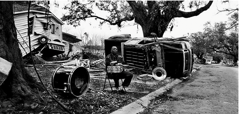 Hurricane Katrina causing severe devastation (https://ellismarsaliscenter.org/musicians-village)