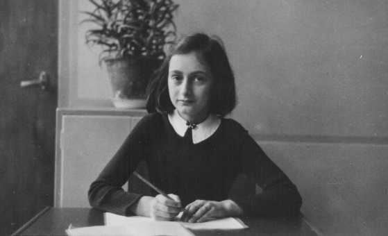 Anne Frank writing in her beloved diary. (www.ushmm.org/wlc/en/article.php)